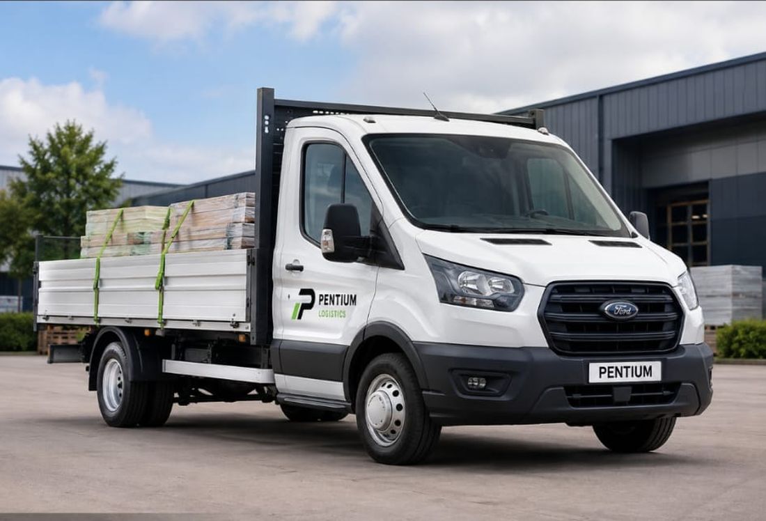 Pentium Logistics Ford Transit drop-side truck loaded with building materials